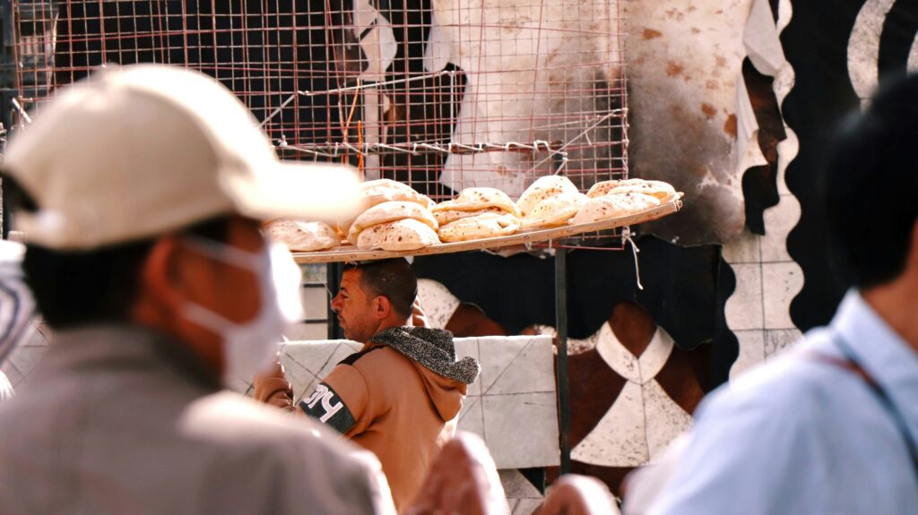 Traditional Egyptian Man Carrying Balady Bread